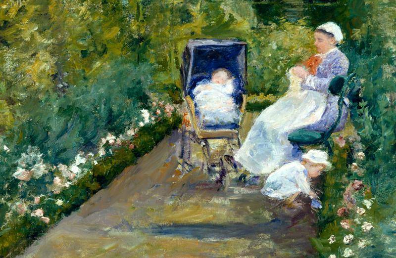 Woman sitting in a park with her infant