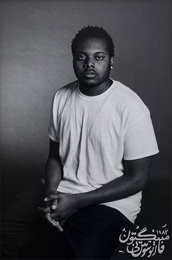 Black and white portrait of Anthony Tobin, a young man in a white t-shirt