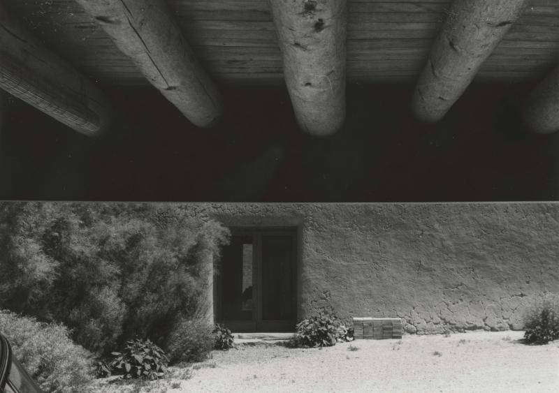 Fotografía en blanco y negro de una puerta de piedra oscura