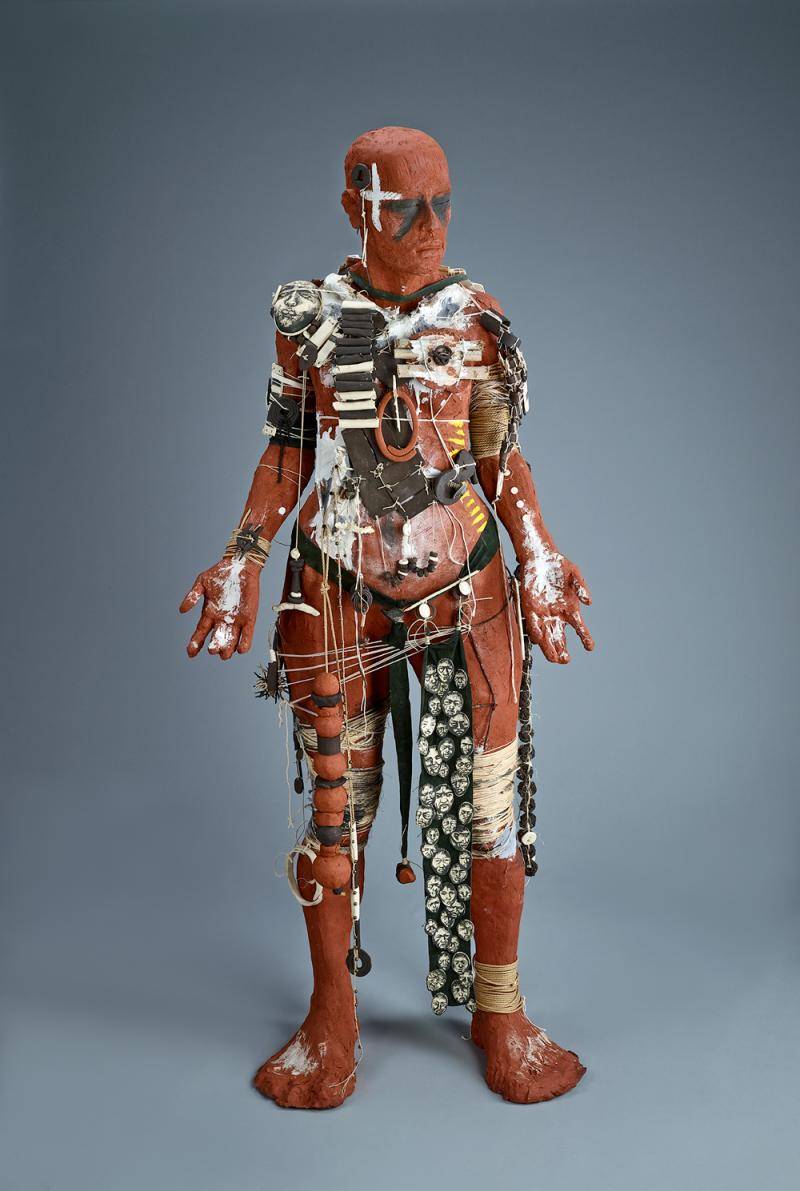 Life-size sculpture of an Indigenous warrior in traditional gear