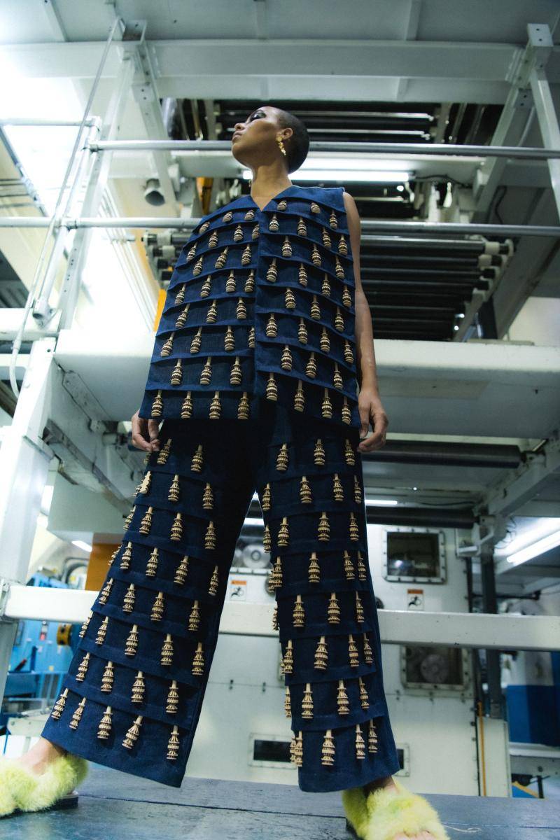 Model wearing patterned vest and pants designed by Carla Fernandez