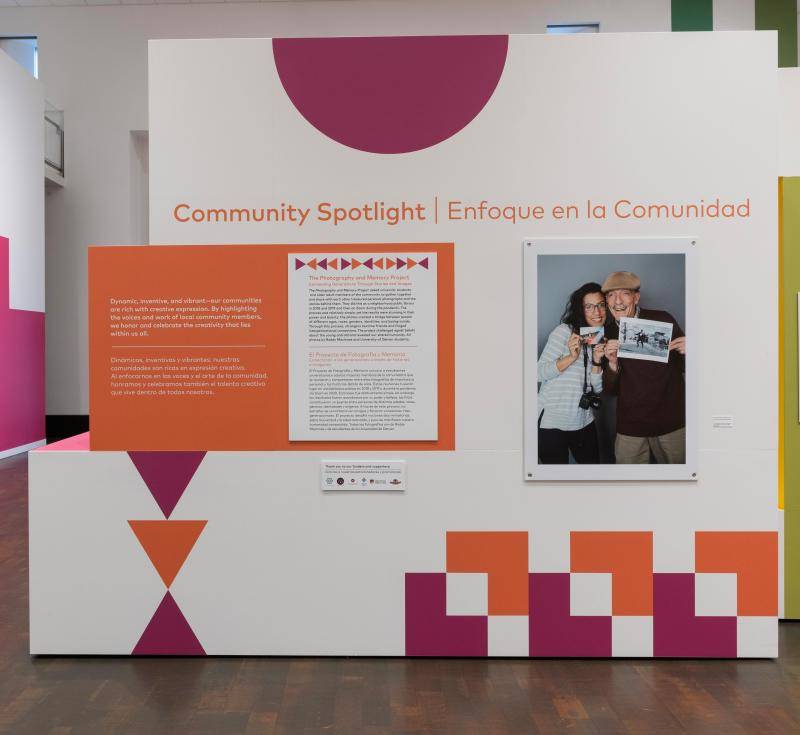 The introductory text and installation of the Community Spotlight photo exhibition
