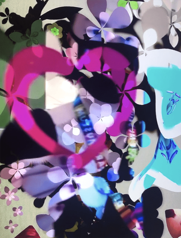 A paper heart shown through on the screen of the artwork "Secret Garden" by Daniel Brown
