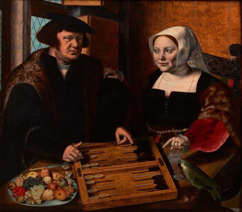 Portrait of a husband and wife sitting and playing a tables game