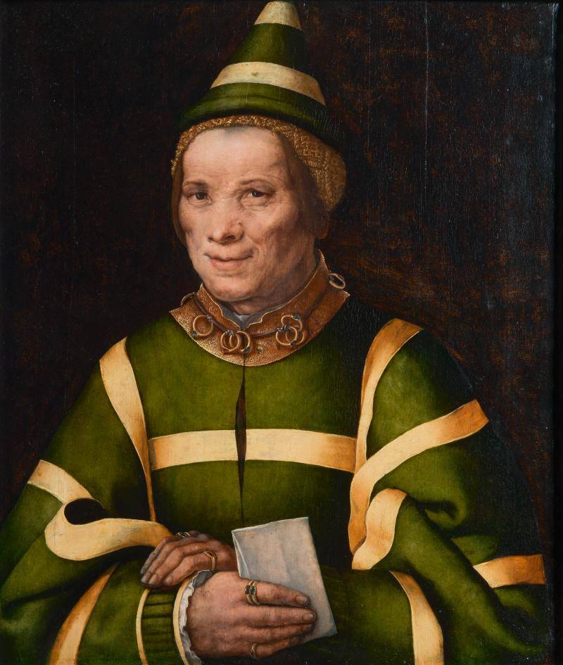 Portrait of a smirking elderly woman in green and gold clothing