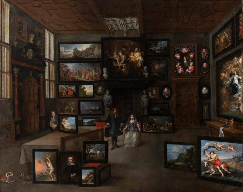 A man and wife posing in a large gallery room covered in paintings 