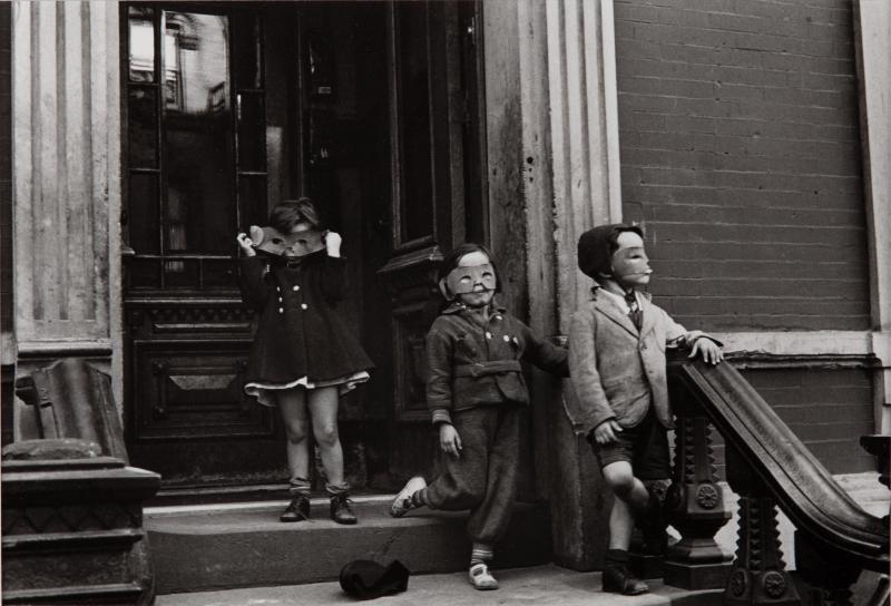Black and white photograph of young children in Halloween-style masks