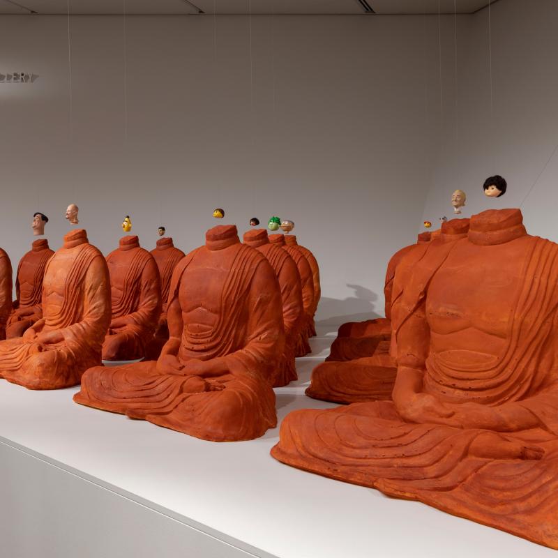 'Headless' by Michael Joo, features headless Buddhas with pop culture icon's heads dangling above them. 