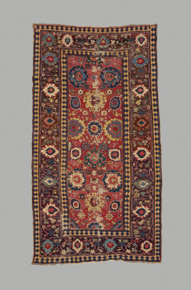 Red rectangular patterned Iranian carpet made out of wool