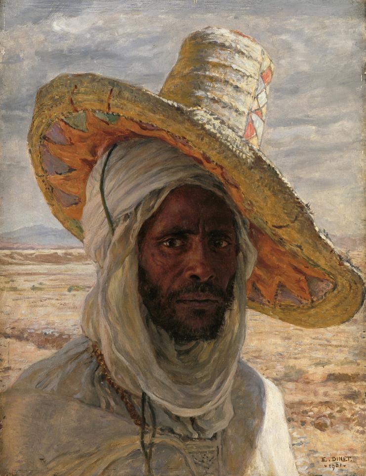 Close-up profile of a man dressed in white with a large straw hat tilted to the side atop his head