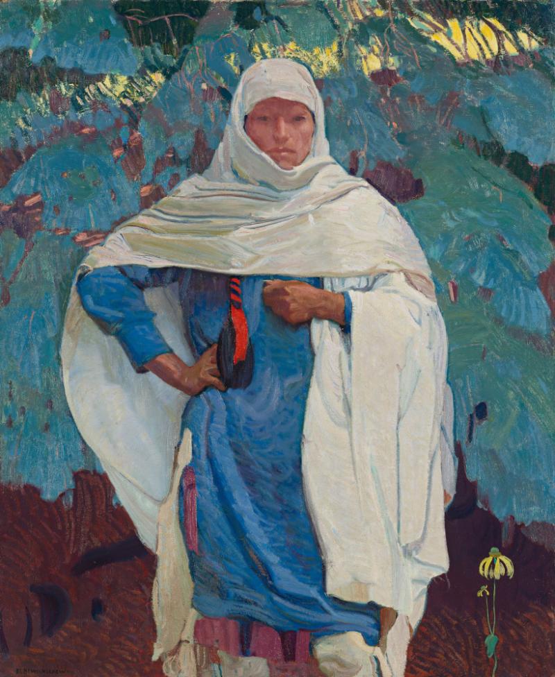 Woman dressed in blue draped in a white head and shoulder covering
