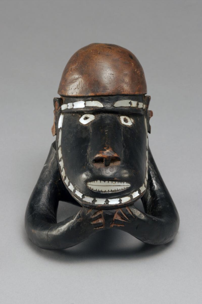 Statue made out of dark wood and pearl made to resemble a Native figure