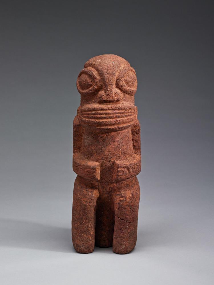 Small stone object of a figure with large eyes and clenched hands