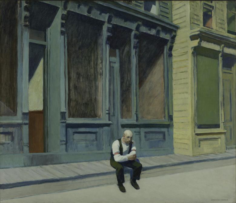 Man sitting contemplatively on the curb outside a shop