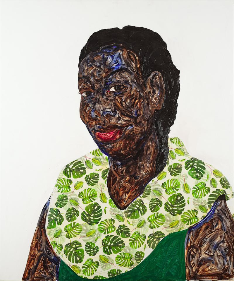 Portrait of a Black woman wearing a green leafy cape
