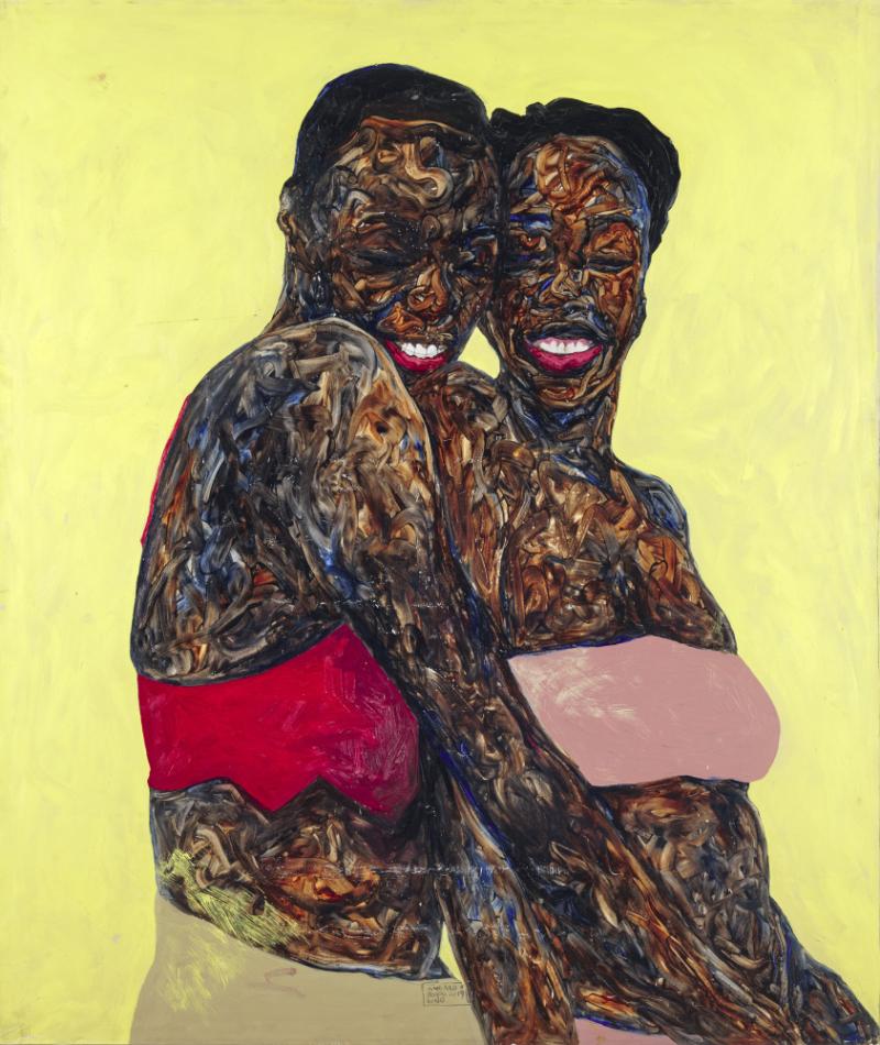Two Black woman embracing and laughing
