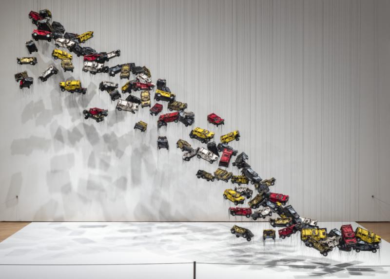Installation made out of vinyl and thread with car model parts