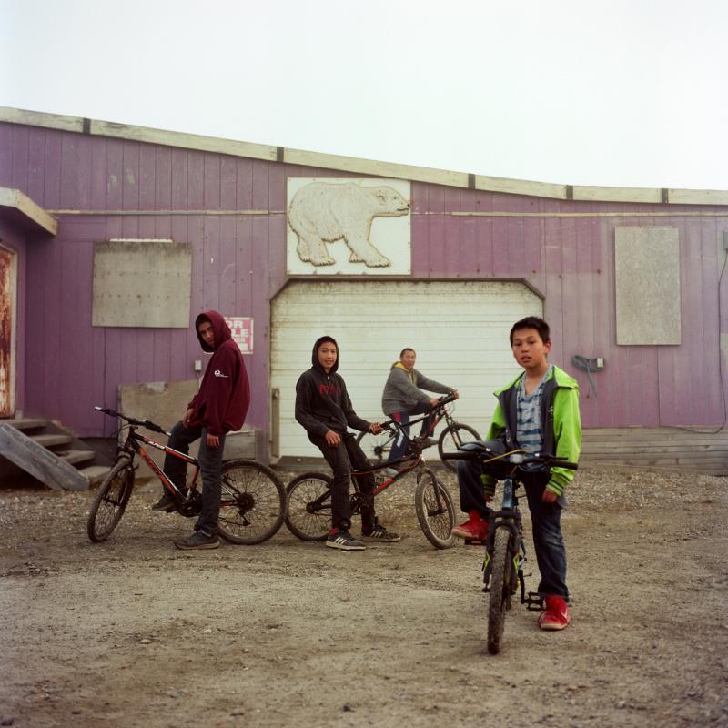 Four young boys on their bikes posing for the camera