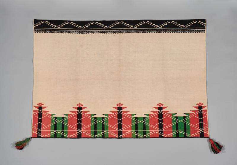 An Acoma Pueblo textile with graphic designs embroidered on the top and bottom