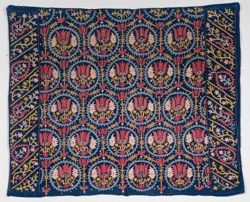 Blue cotton and wool blanket with repeating red floral patterns