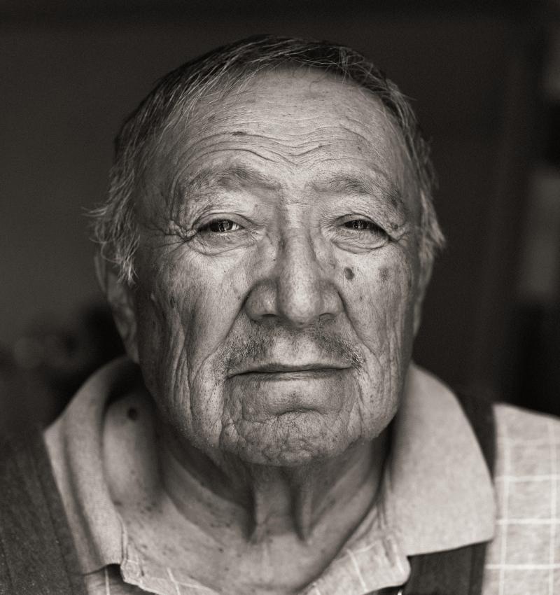 Black and white photograph of an elder Navajo man's face