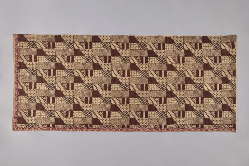Indonesian cotton sarong with repeating brown block and dot patterns