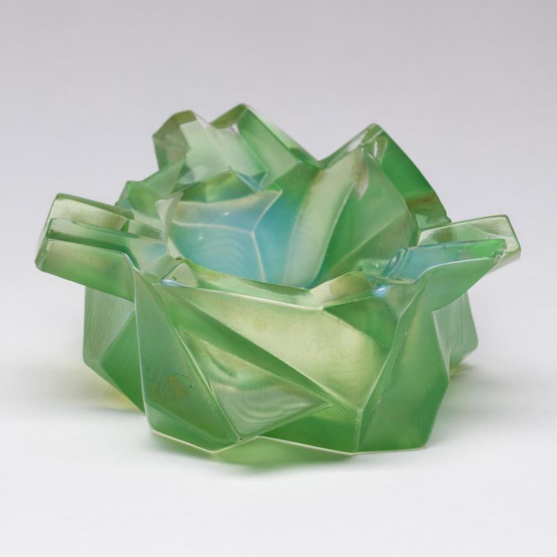 Light green ashtray composed of asymmetrical angles and crisp edges.