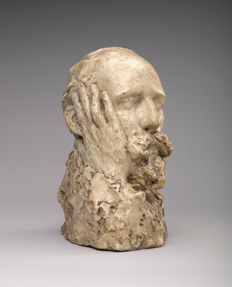 Bust of a man with a hand touching the side of his face