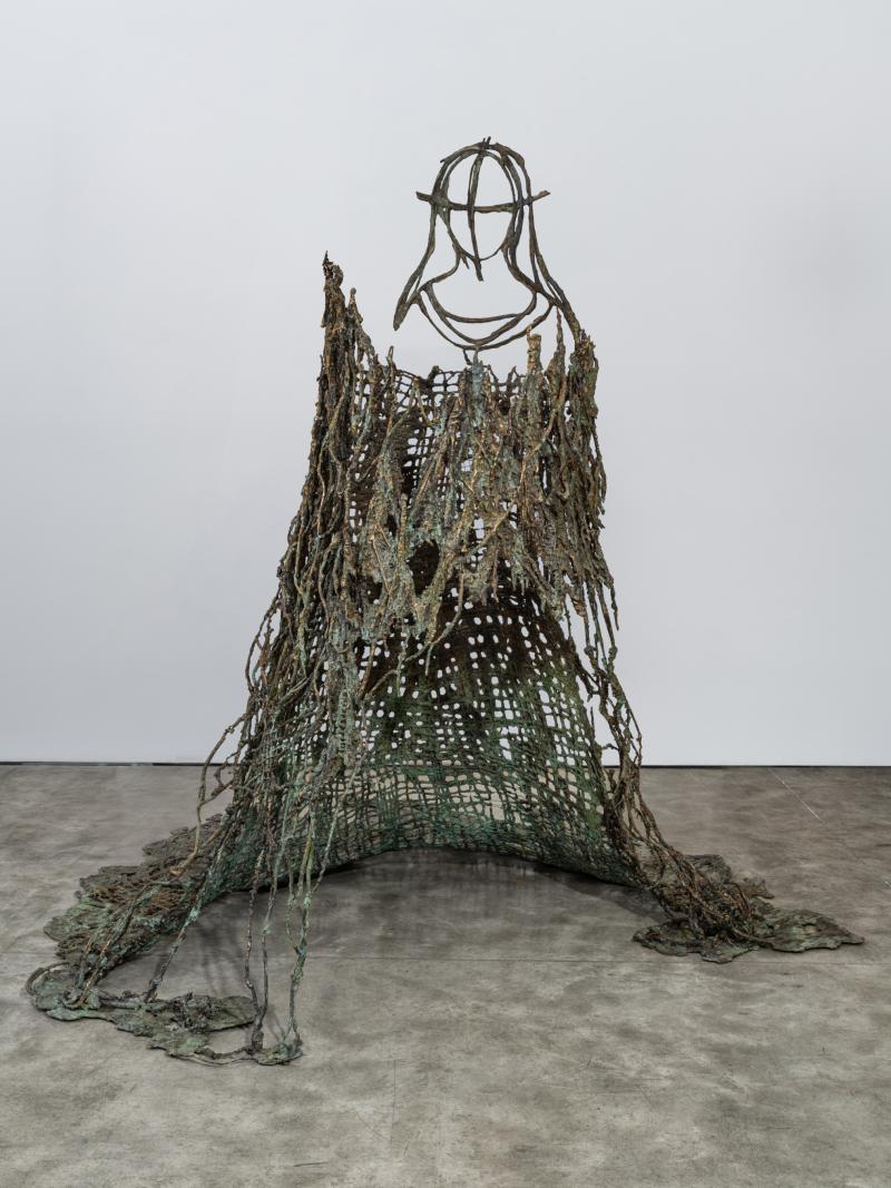 Abstract bronze installation resembling a maiden wearing a large flowing gown