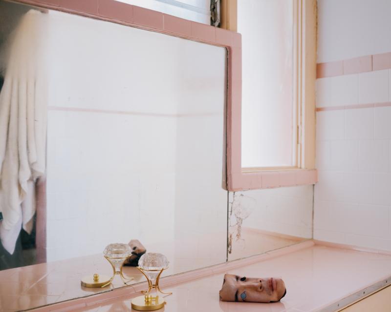 Surreal photo of a severed head resting on top of a cabinet