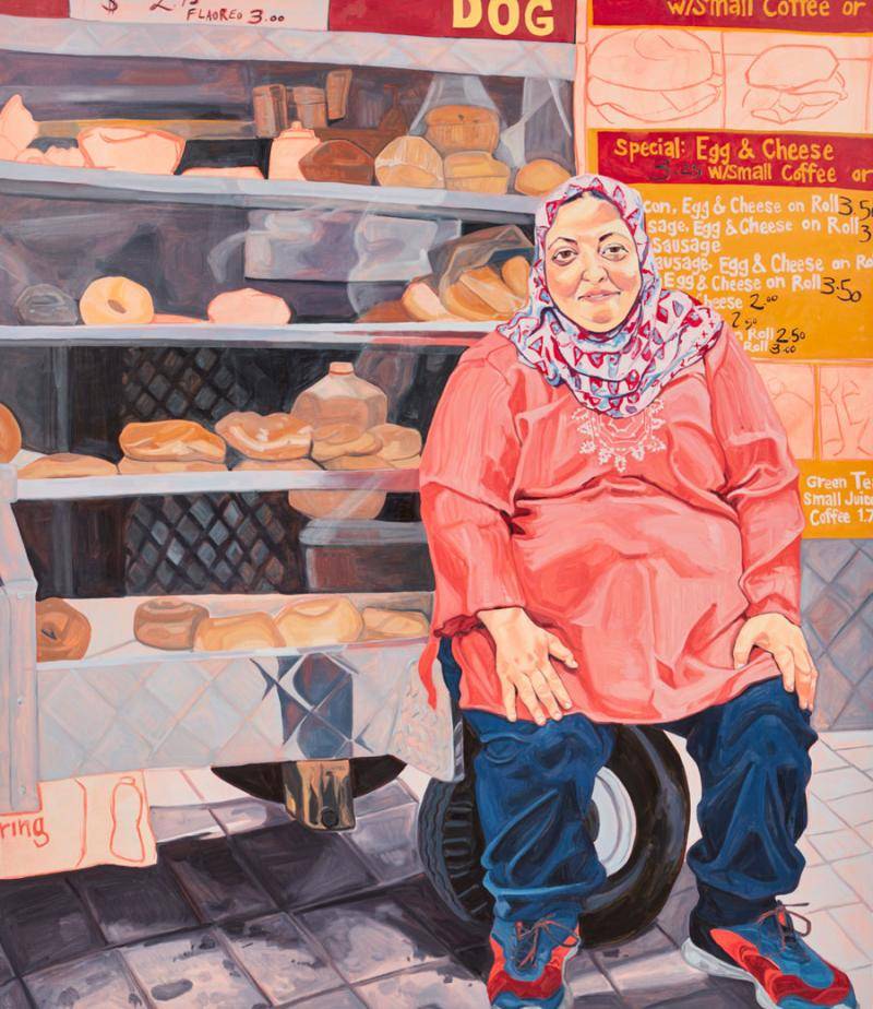 portrait of a woman in front of her food cart in Harlem