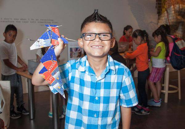 Child with his completed art project during a school field trip at the Denver Art Museum.